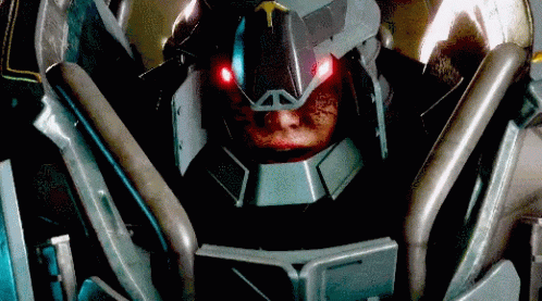 A Close Up Of A Robot With Red Lights On Its Eyes GIF