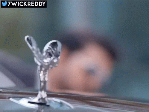 A Close Up Of A Rolls Royce Emblem With 7Wickreddy In The Corner GIF