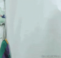 A Close Up Of A Scary Clown With A Red Hat GIF