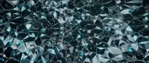 A Close Up Of A Shiny Blue Glass Texture GIF