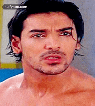 A Close Up Of A Shirtless Man 'S Face With A Beard . GIF