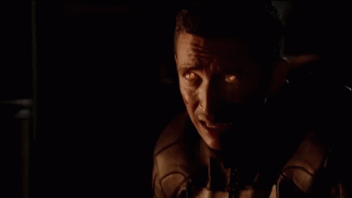 A Close Up Of A Skull With Flames Coming Out Of It 'S Head GIF