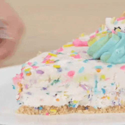 A Close Up Of A Slice Of Cake With Sprinkles On Top GIF