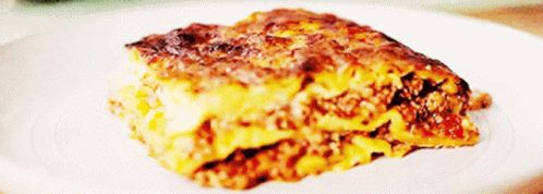 A Close Up Of A Slice Of Lasagna On A Plate GIF