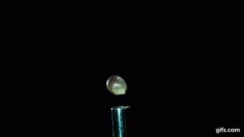 a close up of a smoke coming out of a test tube with gifs.com written on the bottom