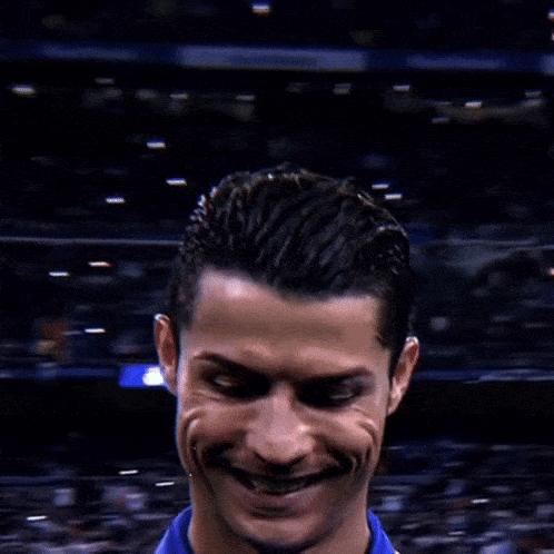 A Close Up Of A Soccer Player 'S Face With A Crowd Behind Him GIF