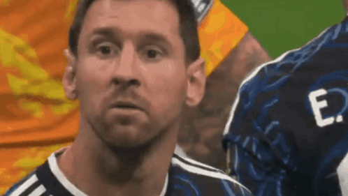 a close up of a soccer player 's face with the letter e on his jersey