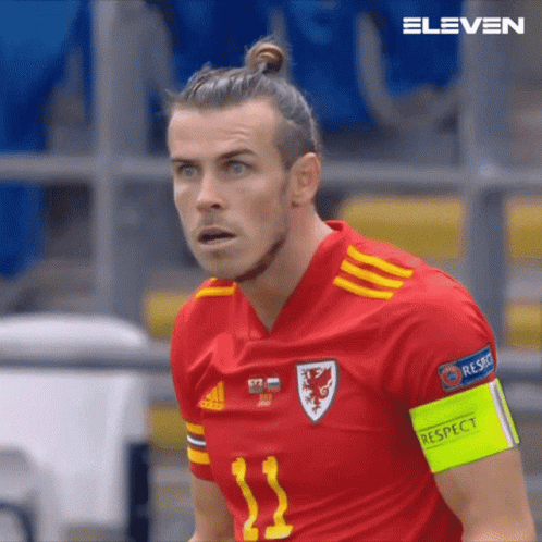 A Close Up Of A Soccer Player Wearing A Red Jersey With The Number 11 On It GIF
