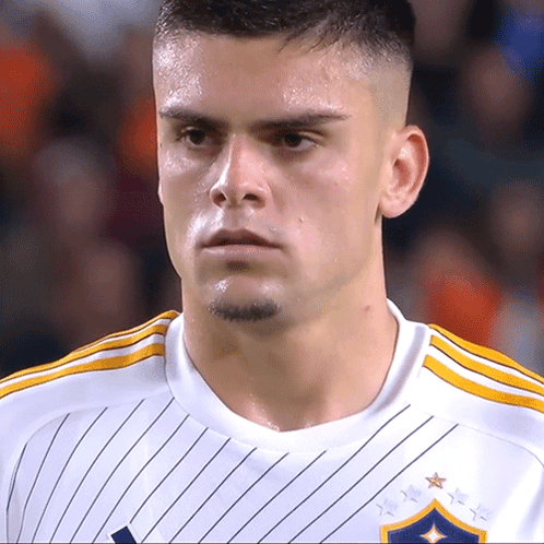 A Close Up Of A Soccer Player Wearing A White Shirt GIF