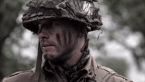 A Close Up Of A Soldier 'S Face With A Helmet On His Head GIF
