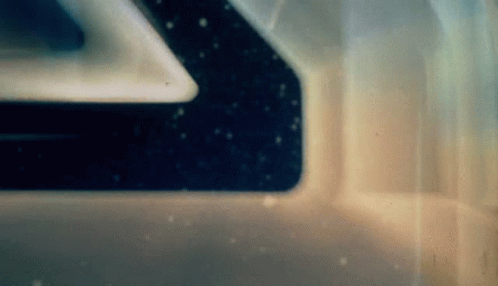A Close Up Of A Space Ship 'S Window With A Reflection Of The Stars In It . GIF