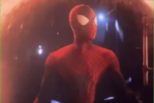 A Close Up Of A Spider-Man In A Red Suit Standing In A Dark Room . GIF