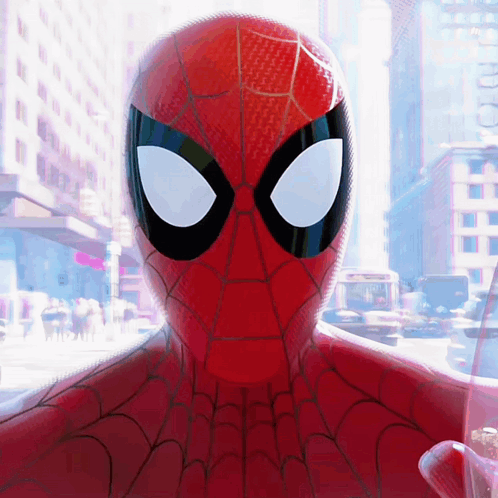A Close Up Of A Spider Man 'S Face With A City Background GIF