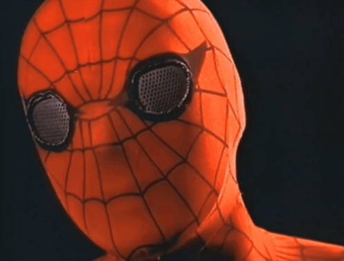 a close up of a spider man 's face with black eyes