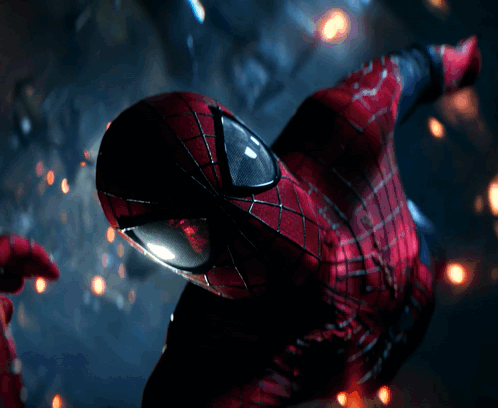 A Close Up Of A Spider Man 'S Face With Glowing Eyes GIF