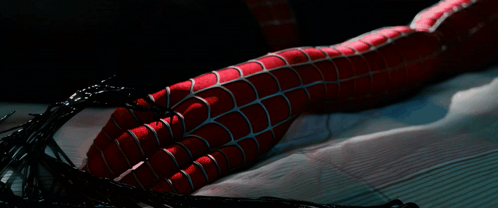 A Close Up Of A Spider Man 'S Leg With Spider Webs Coming Out Of It GIF