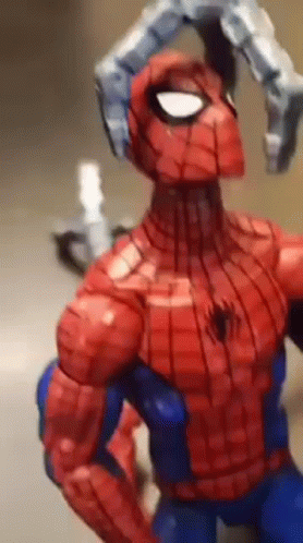 A Close Up Of A Spiderman Action Figure With A Robotic Arm GIF
