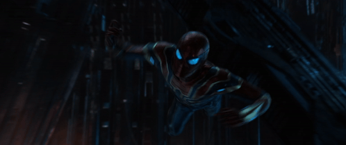 A Close Up Of A Spiderman With Blue Eyes Holding A Spider Web GIF