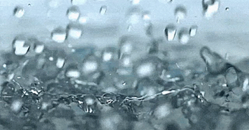 A Close Up Of A Splash Of Water With Bubbles GIF