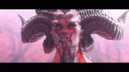 A Close Up Of A Statue Of A Demon With Horns On His Head . GIF
