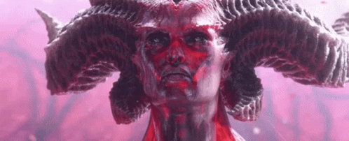 A Close Up Of A Statue Of A Demon With Red Horns . GIF