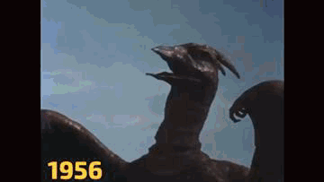 A Close Up Of A Statue Of A Dragon With Its Mouth Open . GIF