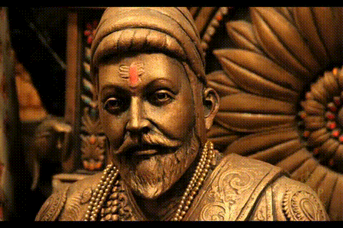 A Close Up Of A Statue Of A Man With A Beard And A Red Bindi On His Forehead GIF