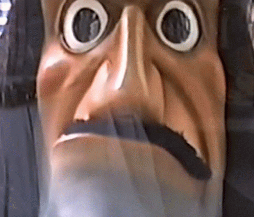 A Close Up Of A Statue Of A Man With A Beard And Big Eyes . GIF