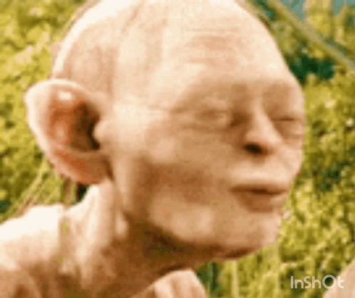 A Close Up Of A Statue Of Gollum From The Lord Of The Rings . GIF