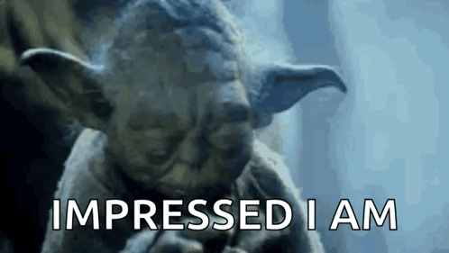 A Close Up Of A Statue Of Yoda Saying Impressed I Am GIF