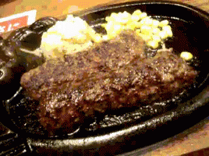 A Close Up Of A Steak On A Sizzling Plate GIF