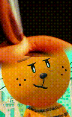 A Close Up Of A Stuffed Animal That Looks Like A Cat GIF