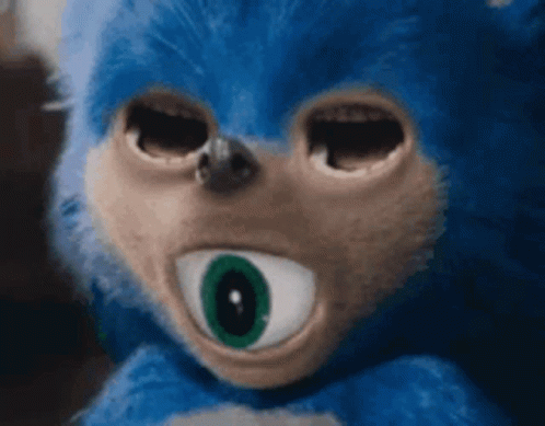 A Close Up Of A Stuffed Animal With A Big Green Eye . GIF