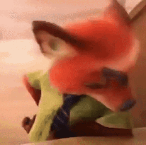 A Close Up Of A Stuffed Animal With A Fox 'S Face On It . GIF