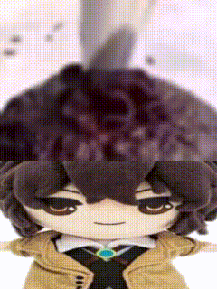 Close Up Of Stuffed Animal With Brown Hair And Hat GIF