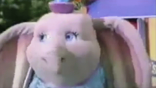 A Close Up Of A Stuffed Elephant With A Hat On GIF