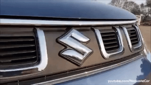 A Close Up Of A Suzuki Logo On A Car GIF