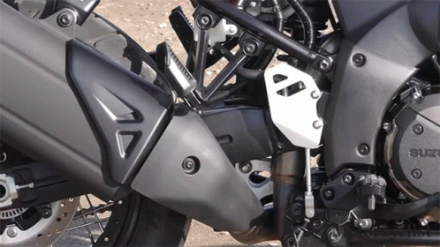 A Close Up Of A Suzuki Motorcycle Engine And Exhaust GIF