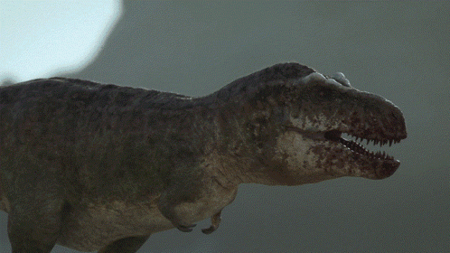 A Close Up Of A T-Rex Dinosaur With Its Mouth Open GIF