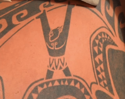 A Close Up Of A Tattoo On A Person 'S Back That Says Vava GIF