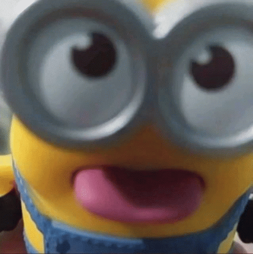 A Close Up Of A Toy Minion With Its Tongue Hanging Out GIF
