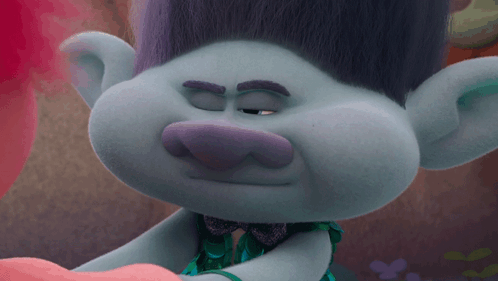 A Close Up Of A Troll With His Eyes Closed And A Bow Tie GIF