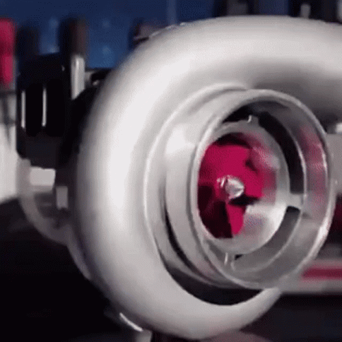 a close up of a turbocharger with a red piston .