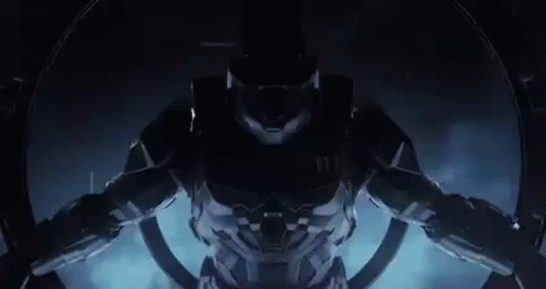 A Close Up Of A Video Game Character In A Futuristic Suit Standing In A Dark Room . GIF