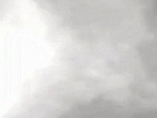 a close up of a waterfall with a lot of fog coming out of it .