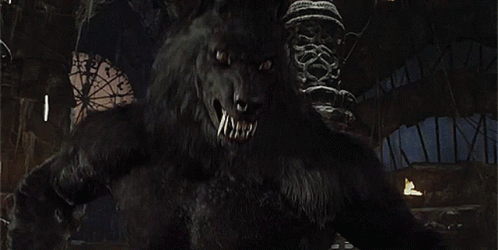 A Close Up Of A Werewolf With Its Mouth Open And Teeth . GIF