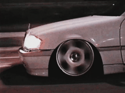 A Close Up Of A White Car With A Lowered Stance GIF