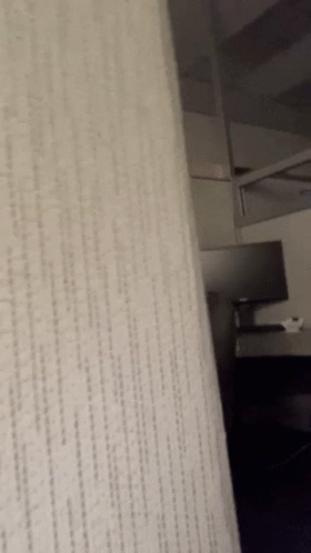 A Close Up Of A White Carpet With A Diagonal Pattern GIF