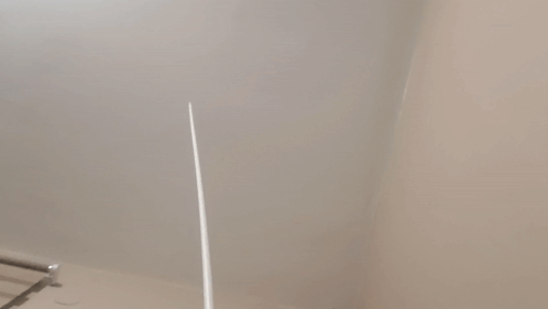 A Close Up Of A White Wall With A Towel Rack GIF
