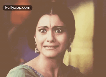 A Close Up Of A Woman Crying With The Words Kulfyapp.com Above Her GIF